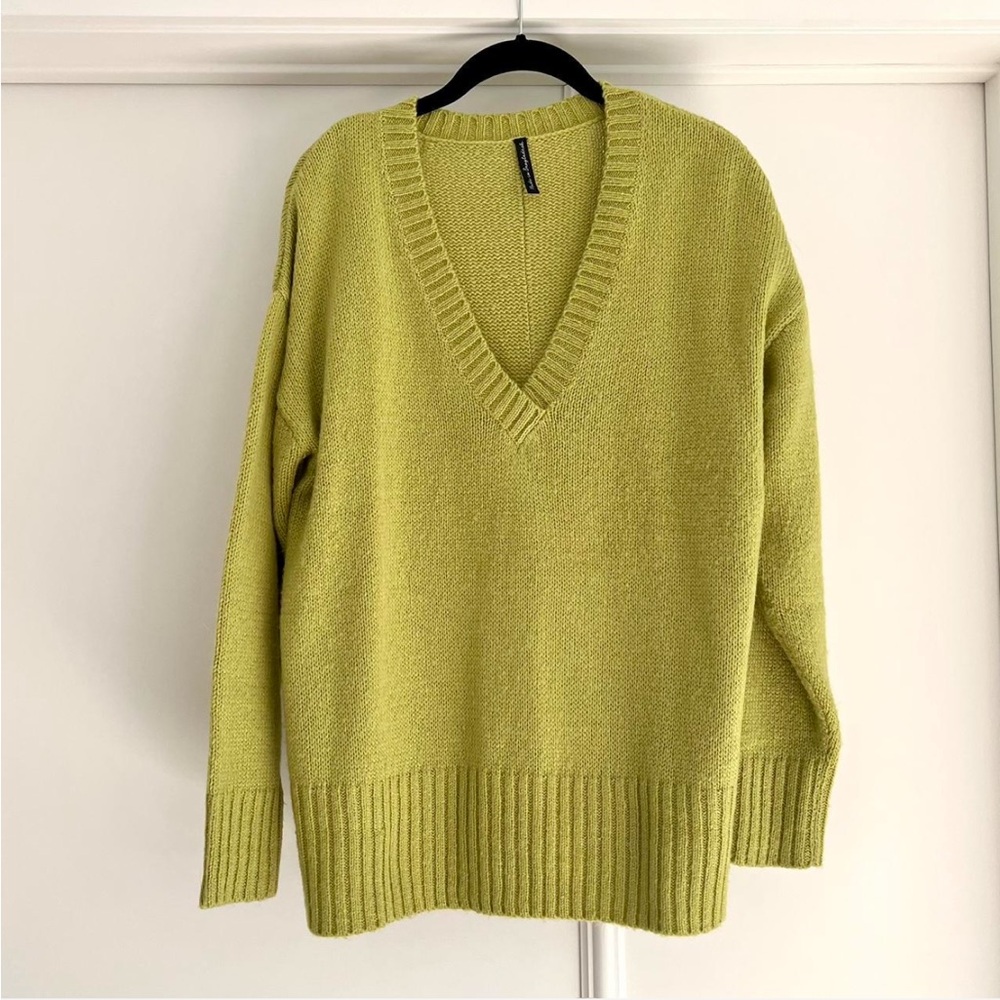 Lime green oversized v-neck sweater with drop shoulders, and back split detail